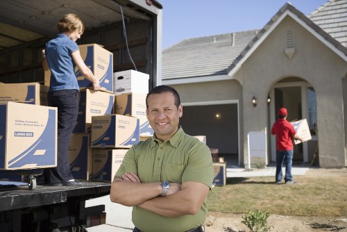Loading furniture into a moving truck for a North London home move