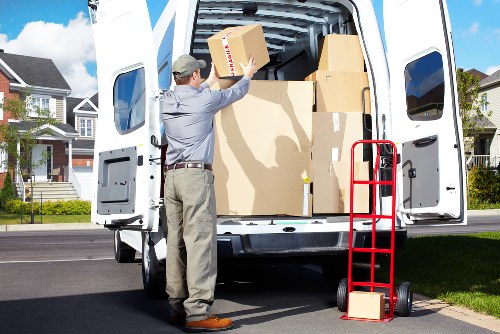 Professional movers carrying household items in a North London flat